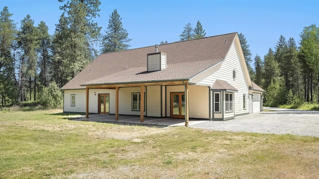 38415 N Hatch Rd, Deer Park, WA 99006 - rear view of house with french doors, a lawn, a chimney, an attached garage, and a shingled roof