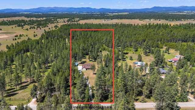 38415 N Hatch Rd, Deer Park, WA 99006 - aerial overview of property's location with a mountainous background and property parcel outlined