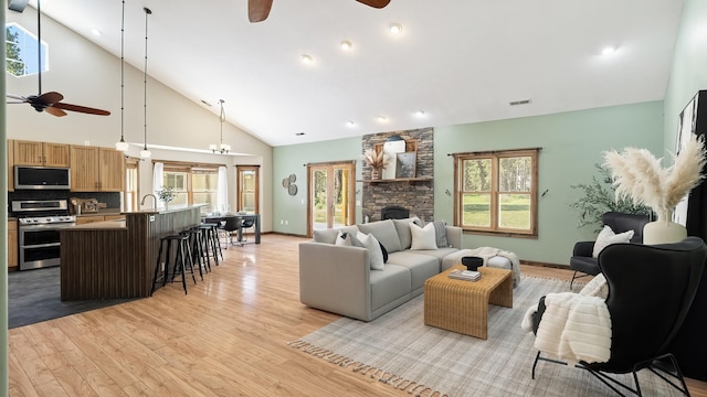 38415 N Hatch Rd, Deer Park, WA 99006 - living room with ceiling fan, high vaulted ceiling, light wood-style floors, and a fireplace
