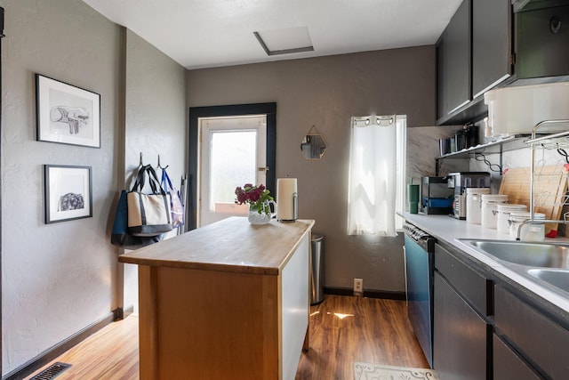 2624 E Boone Ave, Spokane, WA 99202 - kitchen featuring butcher block counters, light wood finished floors, dishwashing machine, open shelves, and a textured wall