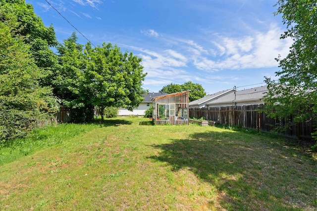 2624 E Boone Ave, Spokane, WA 99202 - fenced backyard with a greenhouse and an outdoor structure