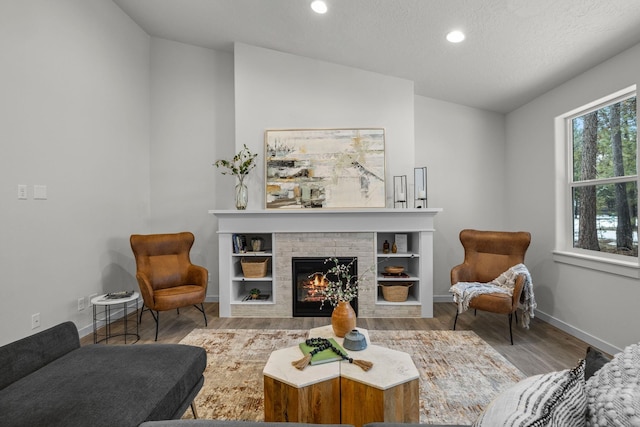 1301 S Roberts Rd, Newport, WA 99156 - living area featuring recessed lighting, a brick fireplace, and wood finished floors