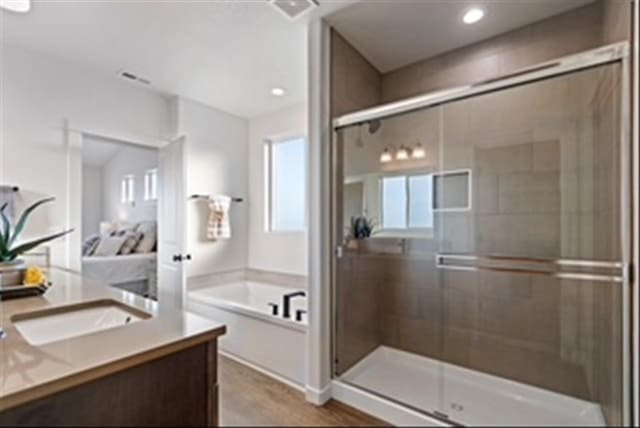 1301 S Roberts Rd, Newport, WA 99156 - bathroom with vanity, a bath, a stall shower, connected bathroom, and recessed lighting