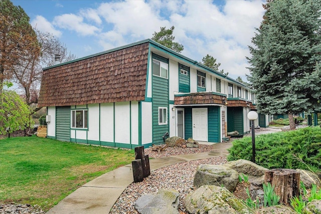 2121 E Upriver Dr Unit # 61, Spokane, WA 99207 - front facade with board and batten siding, a front yard, and mansard roof