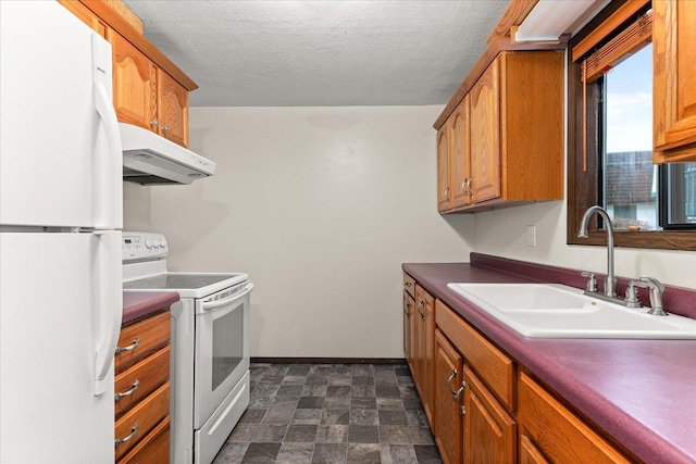 2121 E Upriver Dr Unit # 61, Spokane, WA 99207 - kitchen featuring white appliances, under cabinet range hood, brown cabinets, a textured ceiling, and dark countertops