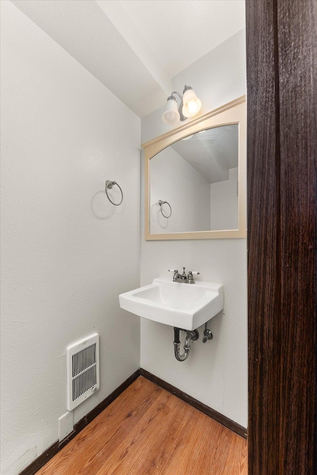 2121 E Upriver Dr Unit # 61, Spokane, WA 99207 - bathroom with heating unit and wood finished floors