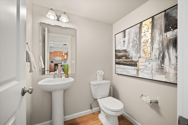 1840 N Wolfe Penn St, Liberty Lake, WA 99019 - half bathroom featuring toilet and wood finished floors