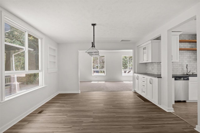 215 E 18th Ave, Spokane, WA 99203 - unfurnished dining area with baseboards and dark wood finished floors