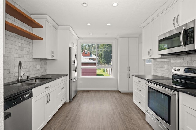 215 E 18th Ave, Spokane, WA 99203 - kitchen with stainless steel appliances, open shelves, wood finished floors, white cabinetry, and recessed lighting