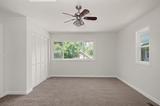 215 E 18th Ave, Spokane, WA 99203 - unfurnished bedroom featuring carpet floors, a closet, and a ceiling fan