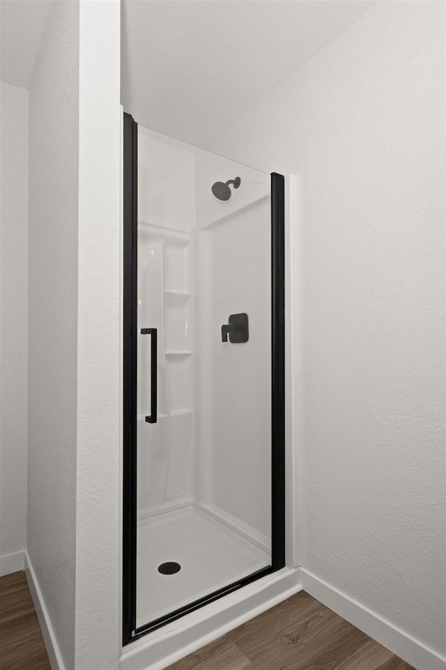 215 E 18th Ave, Spokane, WA 99203 - bathroom featuring a shower stall and wood finished floors