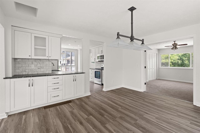 215 E 18th Ave, Spokane, WA 99203 - kitchen featuring appliances with stainless steel finishes, dark countertops, white cabinetry, and backsplash