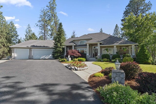 6815 S Palouse Hwy, Spokane, WA 99223 - craftsman inspired home featuring asphalt driveway, a garage, and a porch