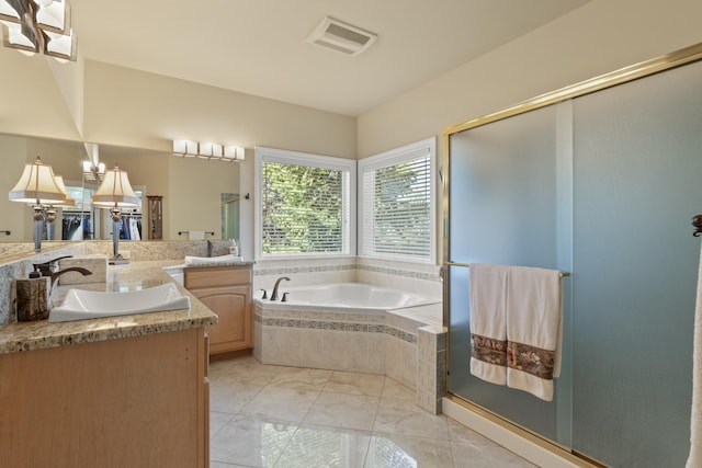 6815 S Palouse Hwy, Spokane, WA 99223 - full bath featuring vanity, marble look tiles, a garden tub, and a shower stall