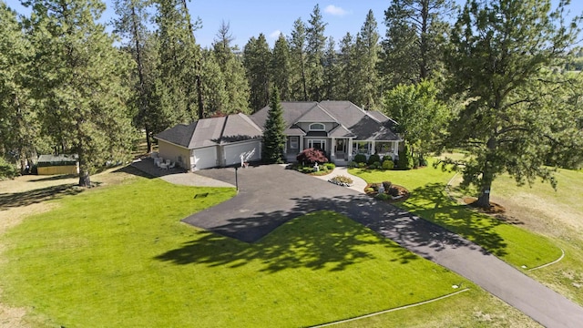 6815 S Palouse Hwy, Spokane, WA 99223 - view of front facade with asphalt driveway, a garage, and a front yard