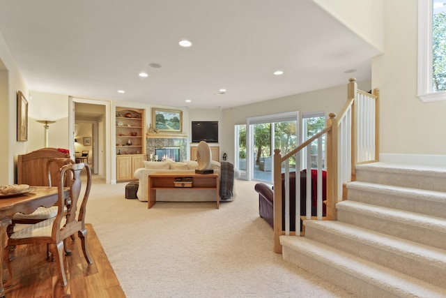 6815 S Palouse Hwy, Spokane, WA 99223 - living area with recessed lighting, stairway, built in shelves, a high end fireplace, and light colored carpet