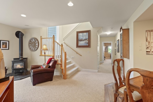 6815 S Palouse Hwy, Spokane, WA 99223 - carpeted living room featuring a wood stove, stairs, and recessed lighting
