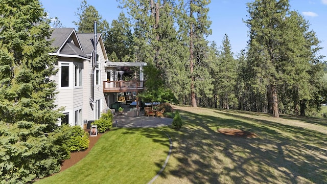 6815 S Palouse Hwy, Spokane, WA 99223 - view of green lawn featuring a patio and a wooden deck