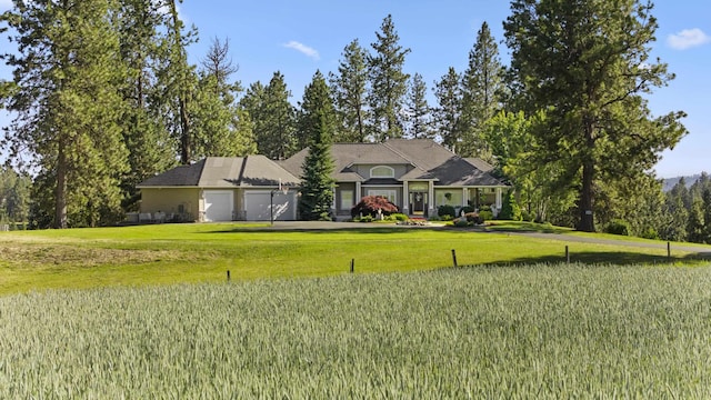 6815 S Palouse Hwy, Spokane, WA 99223 - view of front facade featuring a garage and a front yard