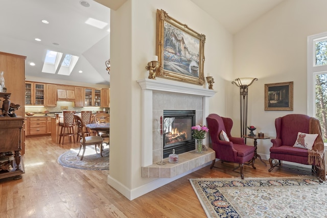 6815 S Palouse Hwy, Spokane, WA 99223 - sitting room featuring a skylight, a fireplace, light wood-style flooring, recessed lighting, and high vaulted ceiling