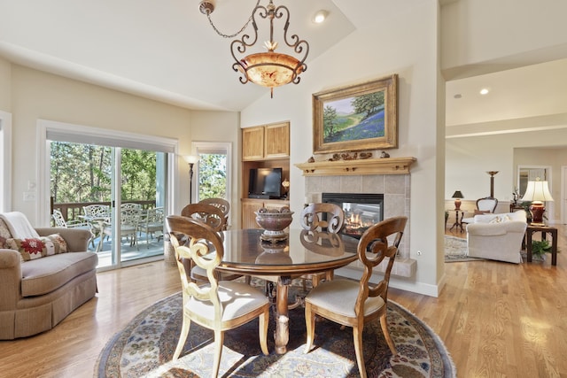 6815 S Palouse Hwy, Spokane, WA 99223 - dining area featuring lofted ceiling, a tiled fireplace, light wood-style flooring, and recessed lighting