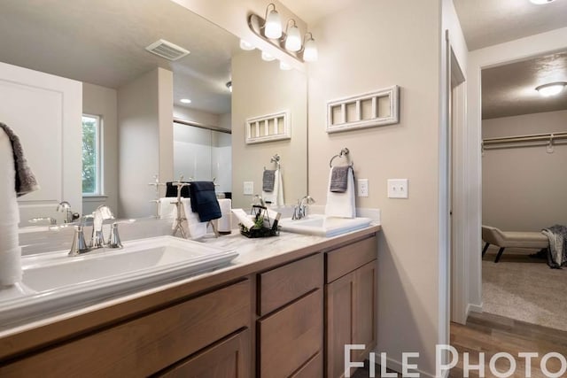 14 N Drummond St, Spokane Valley, WA 99016 - full bath with double vanity, wood finished floors, and a walk in closet