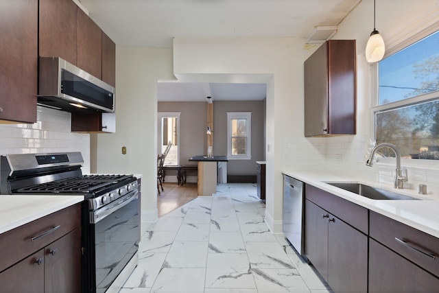 1434 W 8th Ave, Spokane, WA 99204 - kitchen featuring stainless steel appliances, healthy amount of natural light, and light countertops
