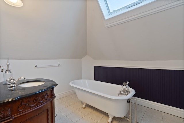 1434 W 8th Ave, Spokane, WA 99204 - bathroom with a soaking tub, vanity, a skylight, tile patterned flooring, and vaulted ceiling
