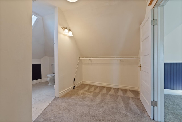 1434 W 8th Ave, Spokane, WA 99204 - walk in closet with vaulted ceiling, carpet floors, and tile patterned floors