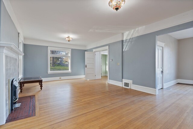 1434 W 8th Ave, Spokane, WA 99204 - unfurnished living room featuring a tiled fireplace and light wood-type flooring