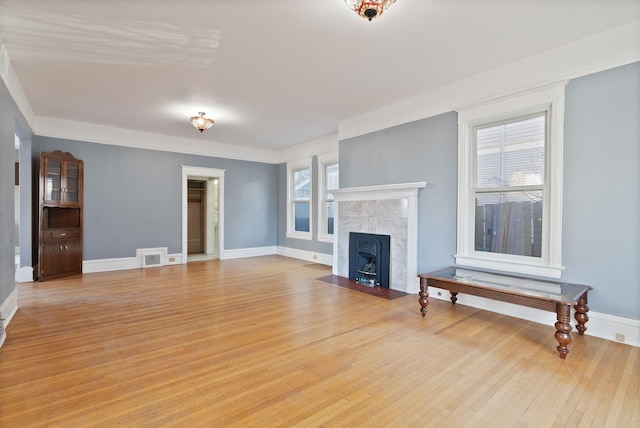 1434 W 8th Ave, Spokane, WA 99204 - unfurnished living room featuring light wood-style flooring and baseboards