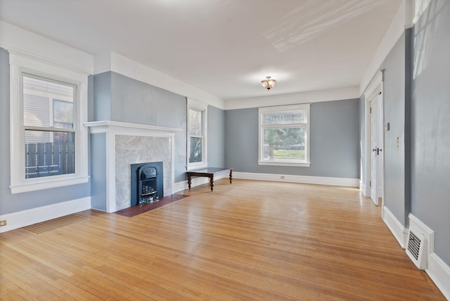 1434 W 8th Ave, Spokane, WA 99204 - unfurnished living room featuring light wood-style flooring and baseboards