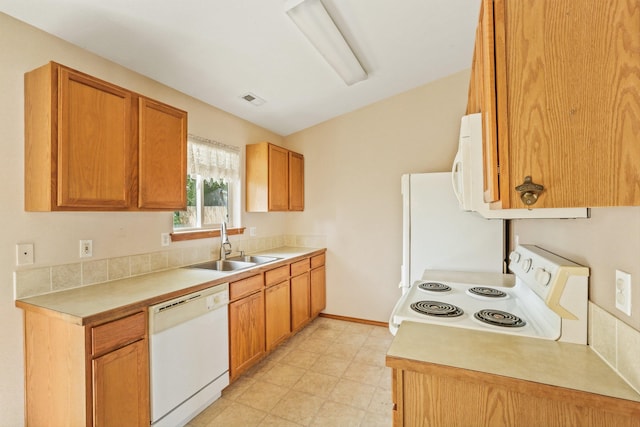 17506 E 3rd Ln, Greenacres, WA 99016 - kitchen featuring white appliances, light countertops, light floors, and brown cabinets