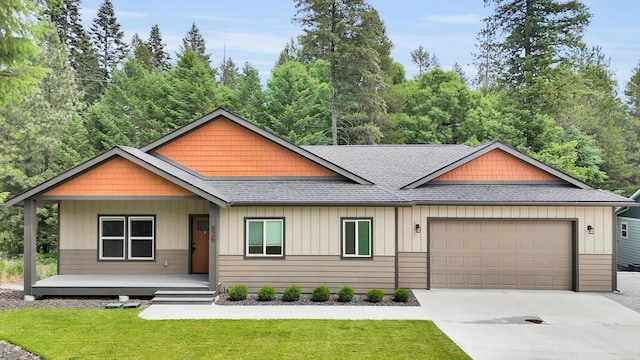826 Thomas Ln, Newport, WA 99156 - view of front of property with a shingled roof, a garage, a porch, concrete driveway, and a front yard