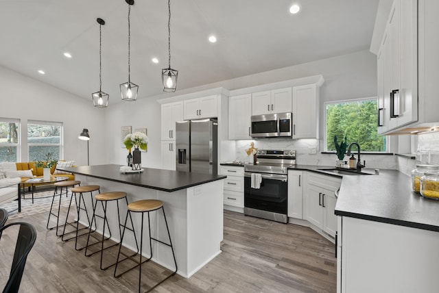 826 Thomas Ln, Newport, WA 99156 - kitchen featuring appliances with stainless steel finishes, a breakfast bar area, tasteful backsplash, healthy amount of natural light, and recessed lighting
