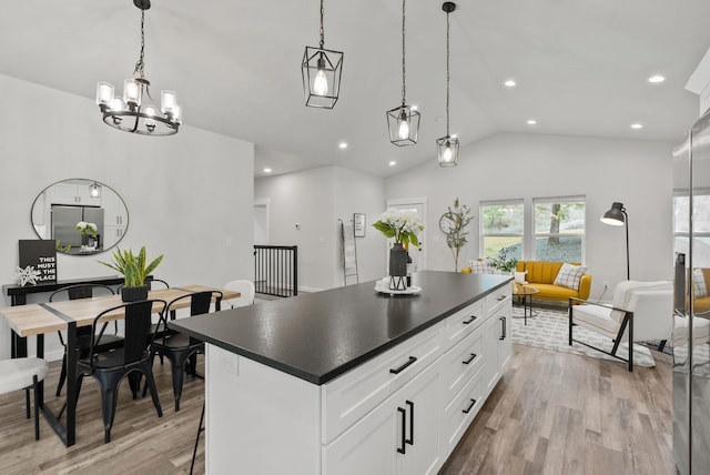 826 Thomas Ln, Newport, WA 99156 - kitchen with dark countertops, light wood finished floors, a center island, lofted ceiling, and recessed lighting
