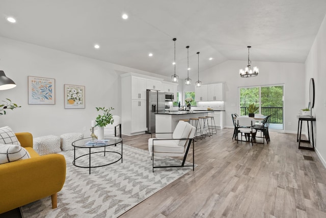 826 Thomas Ln, Newport, WA 99156 - living room with light wood finished floors, a chandelier, high vaulted ceiling, and recessed lighting