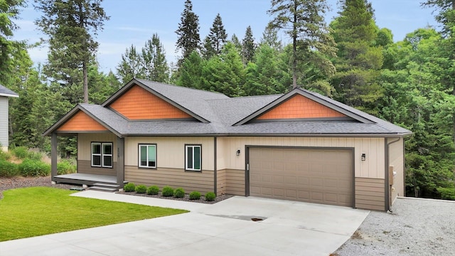 826 Thomas Ln, Newport, WA 99156 - view of front of house with a shingled roof, a garage, concrete driveway, a front lawn, and a porch