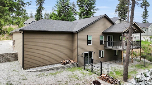 826 Thomas Ln, Newport, WA 99156 - rear view of house with a shingled roof, a gate, a wooden deck, and a fire pit