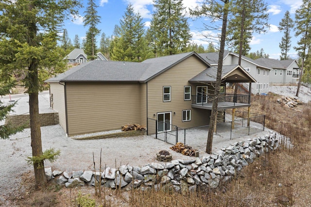 826 Thomas Ln, Newport, WA 99156 - back of property featuring an outdoor fire pit, a shingled roof, a patio, and a deck