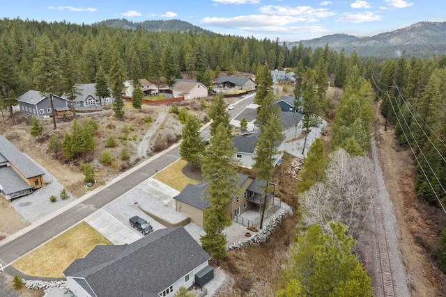 826 Thomas Ln, Newport, WA 99156 - aerial view of residential area with a heavily wooded area and a mountain backdrop