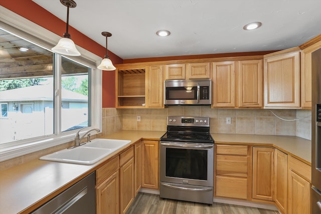 4523 N Royal Ct, Spokane, WA 99205 - kitchen with stainless steel appliances, hanging light fixtures, open shelves, light wood-style flooring, and decorative backsplash