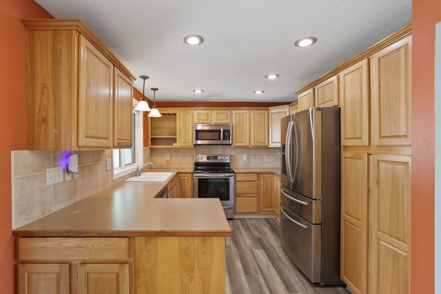 4523 N Royal Ct, Spokane, WA 99205 - kitchen with stainless steel appliances, light brown cabinets, wood finished floors, recessed lighting, and a peninsula