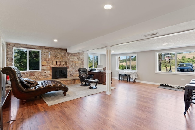 6221 N Highview Ln, Spokane Valley, WA 99217 - living area with wood finished floors, a fireplace, ornate columns, and recessed lighting