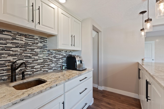 6221 N Highview Ln, Spokane Valley, WA 99217 - kitchen with decorative backsplash, dark wood-type flooring, white cabinets, light stone countertops, and hanging light fixtures