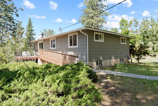 6221 N Highview Ln, Spokane Valley, WA 99217 - view of side of property featuring a wooden deck, a yard, and a chimney