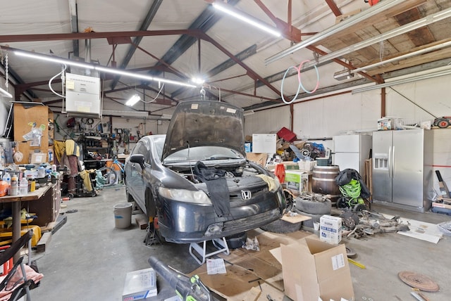 6221 N Highview Ln, Spokane Valley, WA 99217 - garage with fridge with ice dispenser, freestanding refrigerator, and a workshop area
