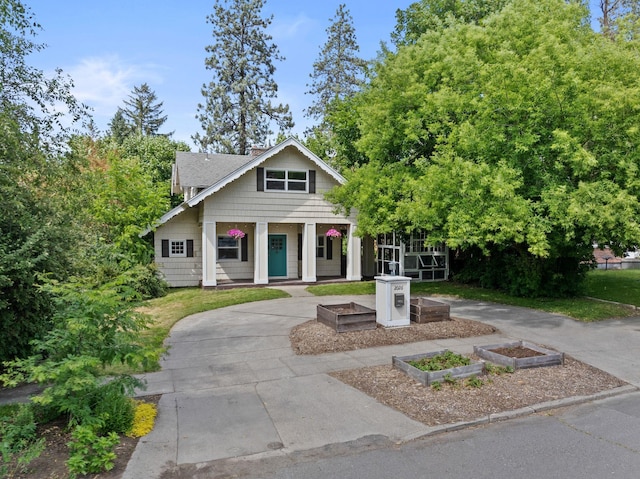 2026 W 9th Ave, Spokane, WA 99204 - view of front of house with a garden, a porch, and a chimney