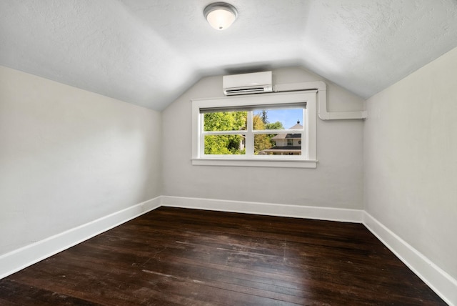 2026 W 9th Ave, Spokane, WA 99204 - bonus room featuring a wall mounted air conditioner, a textured ceiling, hardwood / wood-style floors, and vaulted ceiling