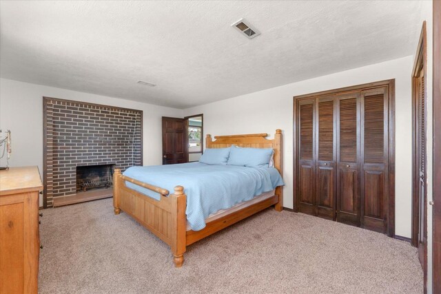 1616 N Ritchey Rd, Reardan, WA 99029 - bedroom with light colored carpet, a brick fireplace, and a textured ceiling